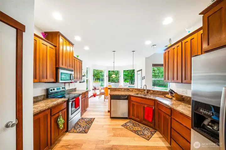 Hickory cabinets match the hickory floors. Stainless steel appliances too!