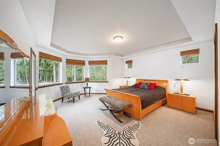 Primary bedroom. Check out the crown molding and lots of windows!