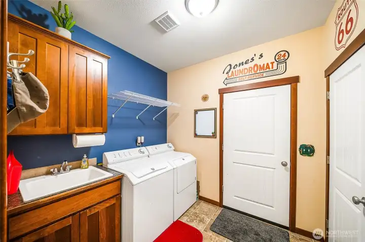 Utility room with sink. Washer and dryer stay with the home.