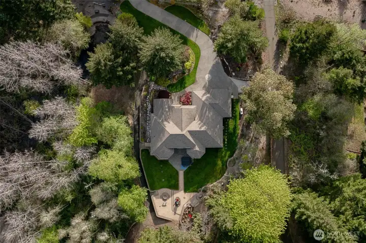 Well designed landscaping with a mixture of grass, fruit trees and trails too.