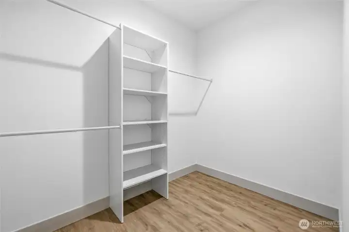 Primary walk in closet. Primary walk in closet.