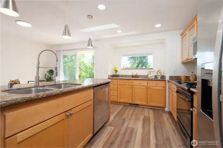 Kitchen Area with dual Stainless Steel Sink, Garbage Disposal,  Dishwasher, Electric Range, Refrigerator and built in Microwavewi and Granite Countertops