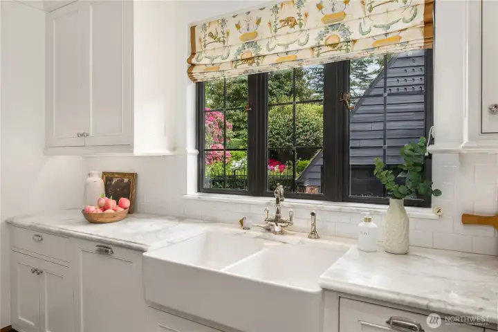 Looking out the kitchen window ~ a big farm style sink and beautiiful stone counters. Looking out the kitchen window ~ a big farm style sink and beautiiful stone counters.