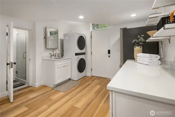 The laundry is in the lower level, the door leads to the outside. There is a 3/4 bathroom-you can see the shower in the photo. The laundry is in the lower level, the door leads to the outside. There is a 3/4 bathroom-you can see the shower in the photo.