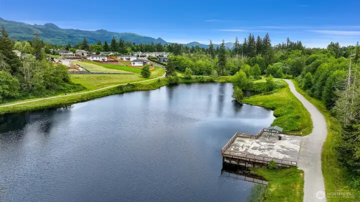 Another aerial view from above the pond towards the property. Another aerial view from above the pond towards the property.