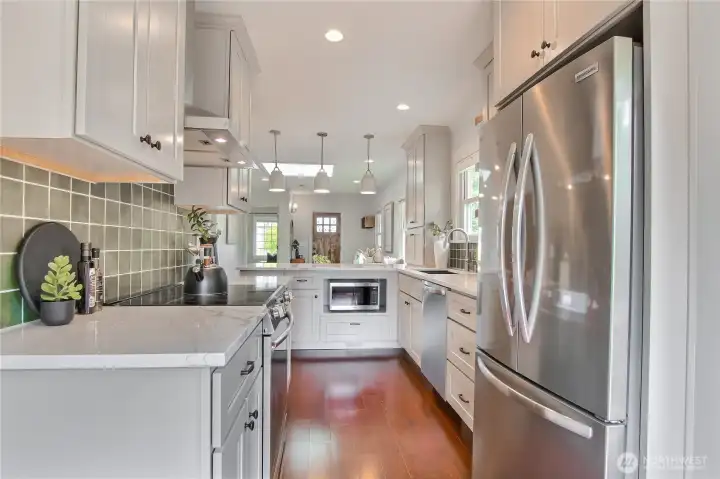 A remodeled kitchen in 2024 with new appliances, and ample counterspace to cook and prepare food.