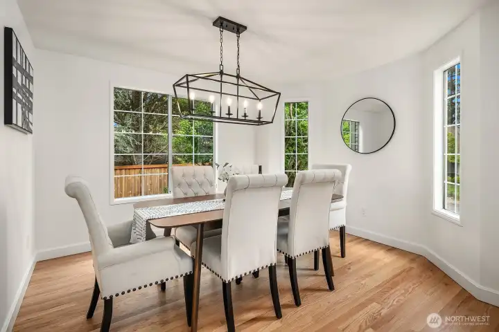 Another angle of the formal dining room highlighting the stylish chandelier, crisp white trim, and warm hardwood floors perfect for hosting dinner parties and family gatherings. Another angle of the formal dining room highlighting the stylish chandelier, crisp white trim, and warm hardwood floors perfect for hosting dinner parties and family gatherings.