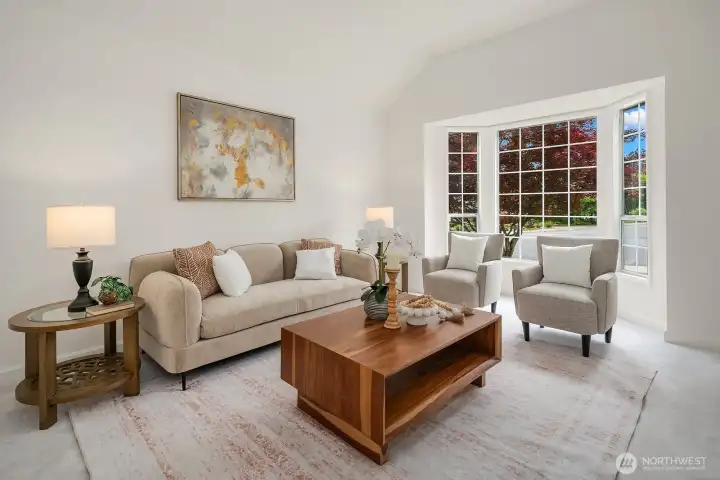 Bright and elegant formal living room featuring soaring vaulted ceilings, large windows, and refined finishes perfect for entertaining or quiet relaxation. Bright and elegant formal living room featuring soaring vaulted ceilings, large windows, and refined finishes perfect for entertaining or quiet relaxation.