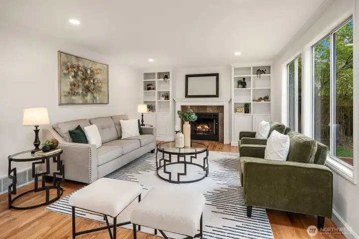 Another angle of the family room showcasing the classic built-ins flanking the gas fireplace, refined finishes, and abundant natural light creating a comfortable and elegant gathering space. Another angle of the family room showcasing the classic built-ins flanking the gas fireplace, refined finishes, and abundant natural light creating a comfortable and elegant gathering space.