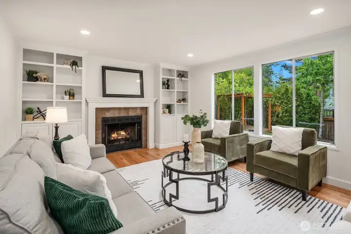 Beautifully styled family room highlighting the cozy fireplace, custom built-ins, and seamless access to the outdoor deck, perfect for relaxed everyday living and entertaining. Beautifully styled family room highlighting the cozy fireplace, custom built-ins, and seamless access to the outdoor deck, perfect for relaxed everyday living and entertaining.