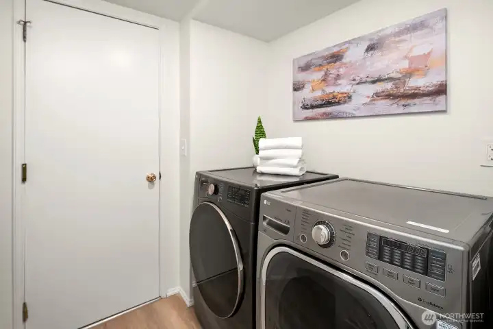 Dedicated laundry room with full size front loading washer and dryer, offering practical everyday convenience on the main level. Dedicated laundry room with full size front loading washer and dryer, offering practical everyday convenience on the main level.