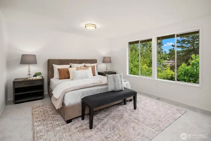Expansive east facing primary suite bathed in morning light, featuring new carpet, serene treetop views, and a spacious layout that serves as a true retreat. Expansive east facing primary suite bathed in morning light, featuring new carpet, serene treetop views, and a spacious layout that serves as a true retreat.