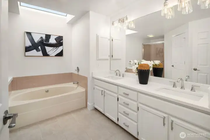 Luxurious 5-piece primary ensuite featuring a soaking tub, dual vanity, and elegant finishes that complete this exceptional primary retreat. Luxurious 5-piece primary ensuite featuring a soaking tub, dual vanity, and elegant finishes that complete this exceptional primary retreat.