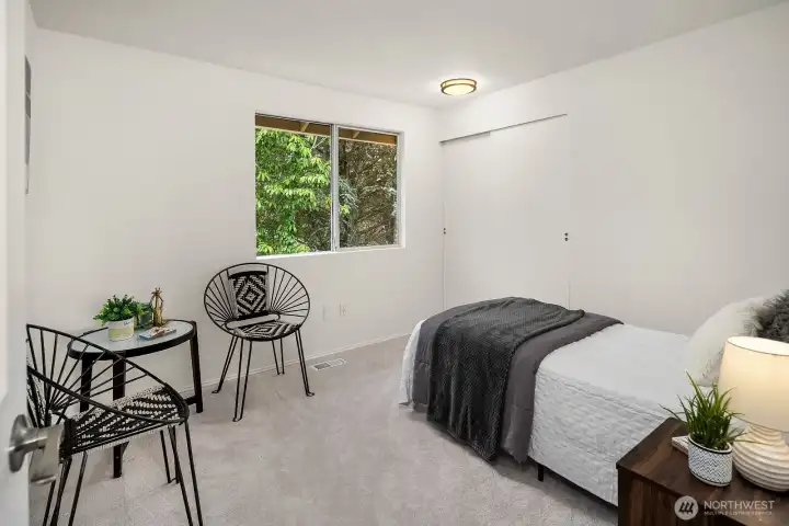 Additional bedroom with new carpet and a cozy window nook, offering a flexible and comfortable space for family or guests. Additional bedroom with new carpet and a cozy window nook, offering a flexible and comfortable space for family or guests.