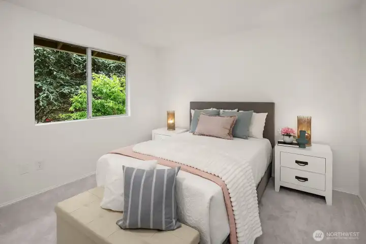 Bright and cheerful bedroom with new carpet and lush greenery visible through the window, creating a peaceful and restful environment. Bright and cheerful bedroom with new carpet and lush greenery visible through the window, creating a peaceful and restful environment.