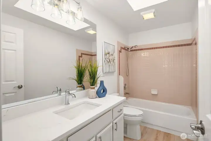 Full upper level bathroom featuring a clean tub and shower combo, updated vanity, and fresh finishes to comfortably serve the additional bedrooms. Full upper level bathroom featuring a clean tub and shower combo, updated vanity, and fresh finishes to comfortably serve the additional bedrooms.