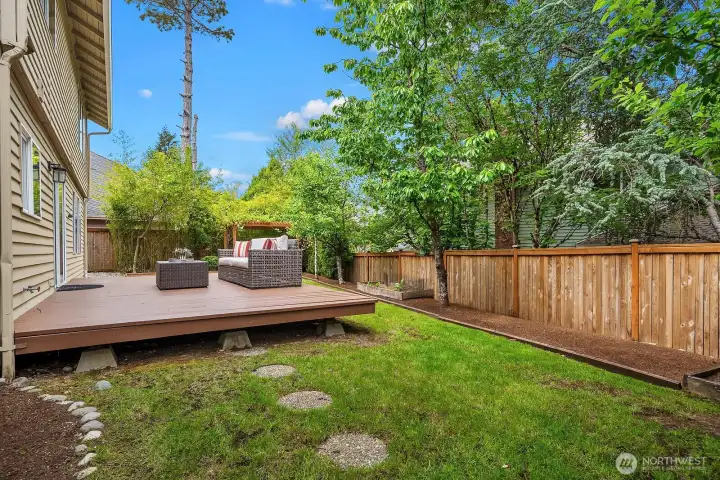 Expansive fully fenced backyard with a generous lawn area, mature landscaping, and the deck just steps away, offering endless possibilities for outdoor living and play. Expansive fully fenced backyard with a generous lawn area, mature landscaping, and the deck just steps away, offering endless possibilities for outdoor living and play.