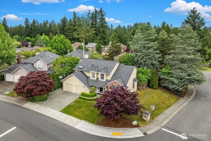 Aerial view of the home's prime corner lot location within the Klahanie community, showcasing the lush landscaping, mature trees, and well-maintained neighborhood surroundings. Aerial view of the home's prime corner lot location within the Klahanie community, showcasing the lush landscaping, mature trees, and well-maintained neighborhood surroundings.