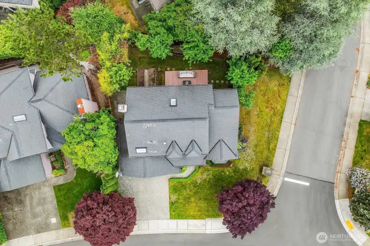 Top-down aerial view showcasing the beautifully landscaped front yard, classic roofline, and the home's inviting corner lot presence within the Klahanie community. Top-down aerial view showcasing the beautifully landscaped front yard, classic roofline, and the home's inviting corner lot presence within the Klahanie community.