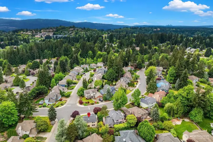 Expansive aerial view of Klahanie's beautifully maintained streets and lush tree canopy, with the Cascade Mountain range providing a spectacular backdrop to this premier Sammamish neighborhood. Expansive aerial view of Klahanie's beautifully maintained streets and lush tree canopy, with the Cascade Mountain range providing a spectacular backdrop to this premier Sammamish neighborhood.