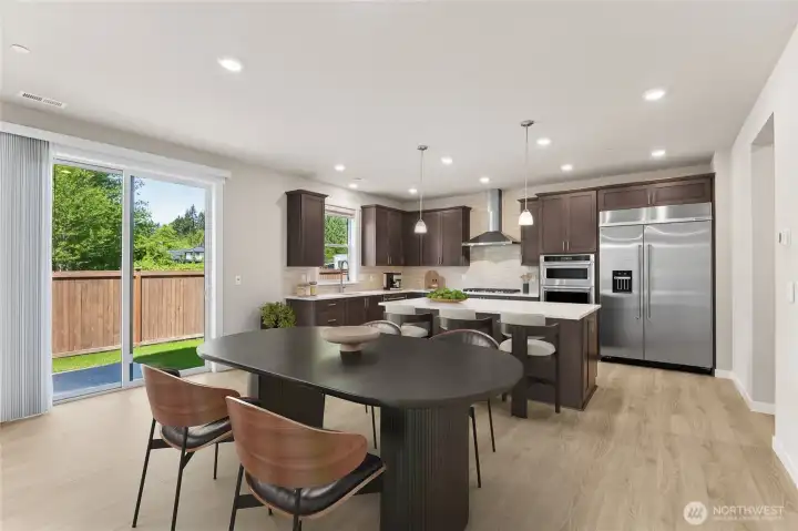 Spacious kitchen and informal dining area - virtually staged. Cabinet color may be different than actual home. Spacious kitchen and informal dining area - virtually staged. Cabinet color may be different than actual home.