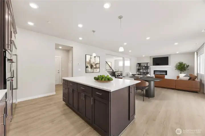 Kitchen opens to informal dining and great room - virtually staged. Cabinet color may be different than actual home. Kitchen opens to informal dining and great room - virtually staged. Cabinet color may be different than actual home.
