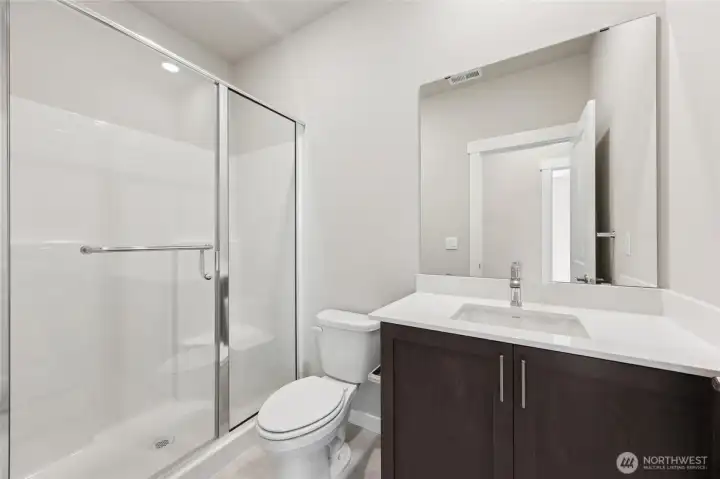 Single sink, walk in shower and toilet in this 3/4 bathroom situated next to main floor bedroom. Single sink, walk in shower and toilet in this 3/4 bathroom situated next to main floor bedroom.