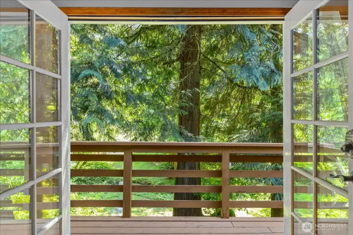 French doors open to upper level deck with separarte staircase