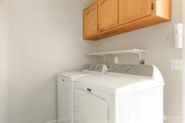Great size laundry room with extra storage space.