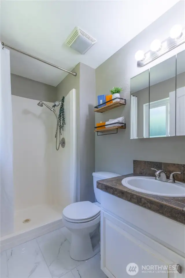 Primary bathroom with tile flooring.