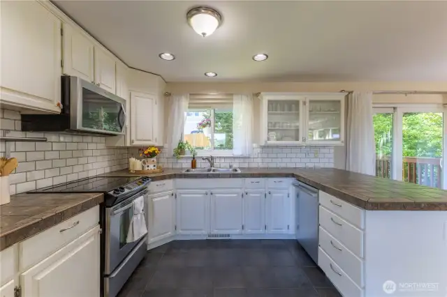 White kitchen with subway tile and stainless steel appliances
