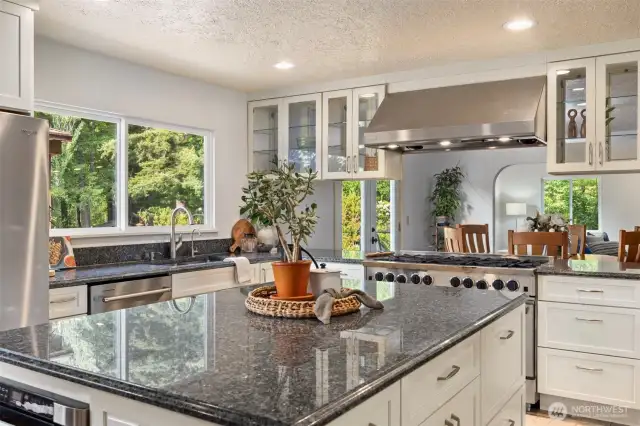A large island with a built-in microwave and plenty of space to gather and curate your meals