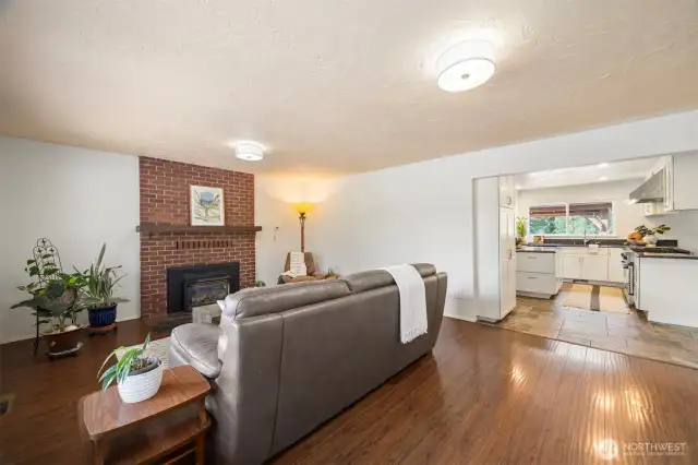 A more formal living room with a gas fireplace overlooks the front of the home and approach.