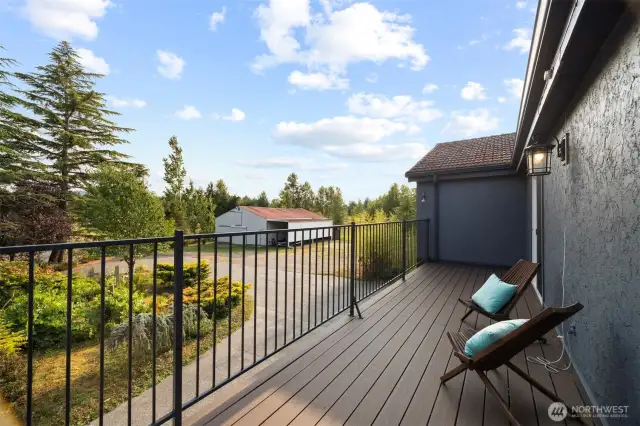 Upstairs, two bedrooms share access to a generous sun balcony overlooking English gardens and the foothills beyond.