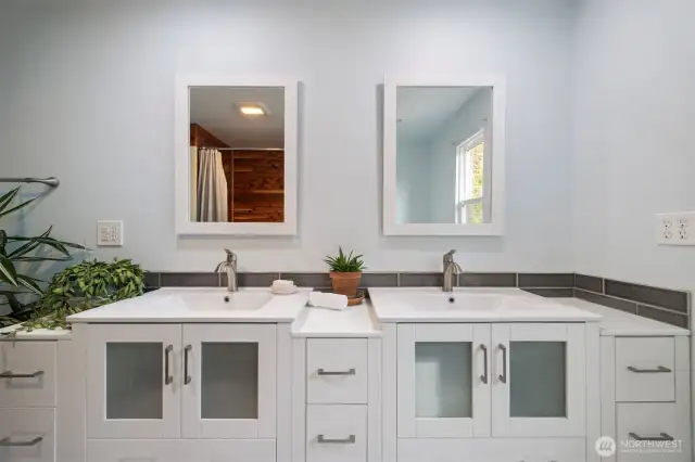 Full bathroom with double vanities.