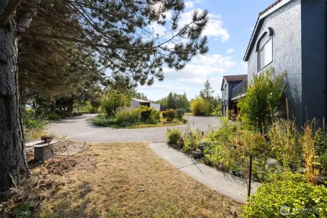 This home has it all with a circle driveway and paved paths around the home... English gardens, fruit trees, berries and raised garden beds.