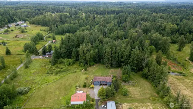 Spanning over 4,000 sq ft, the residence sits on a captivating 8+ acre parcel—half lush woods with meandering trails, half sun-drenched open space, all infused with privacy and natural beauty.