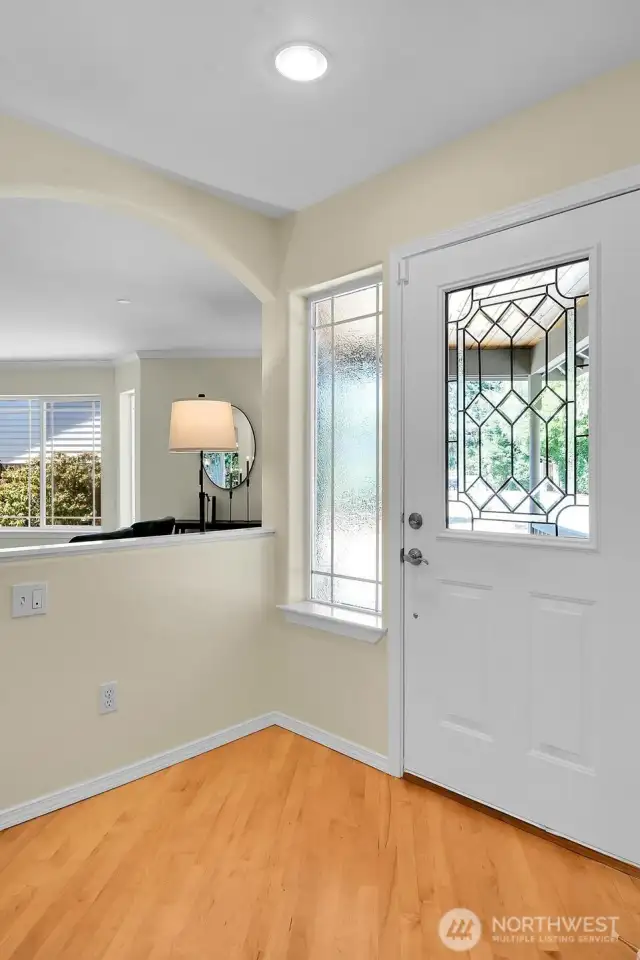 Maple hardwoods and a coat closet (off camera) grace the formal entry to this move-in ready home.