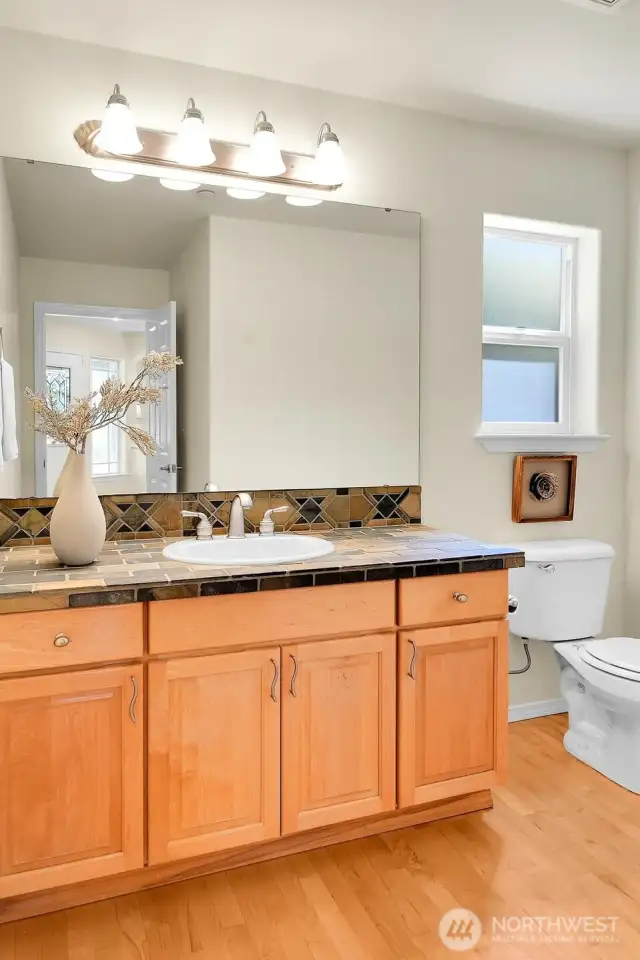 An enormous powder room with more hardwood floors adds convenience to the main floor.
