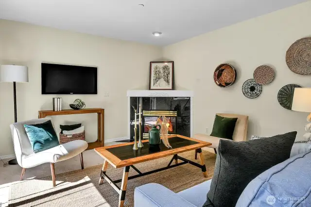 A convenient gas fireplaces adds warmth and coziness  to the den with the flip of a switch.