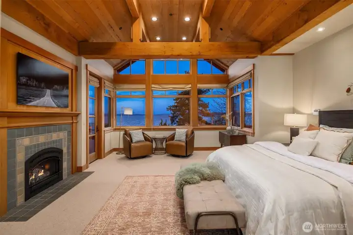 Incredible main floor owners' suite- Vaulted ceilings, lake views, private door to the deck & cozy, gas fireplace.