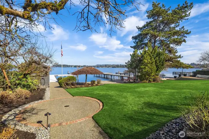 Level lawn with lake irrigation & landscape lighting.