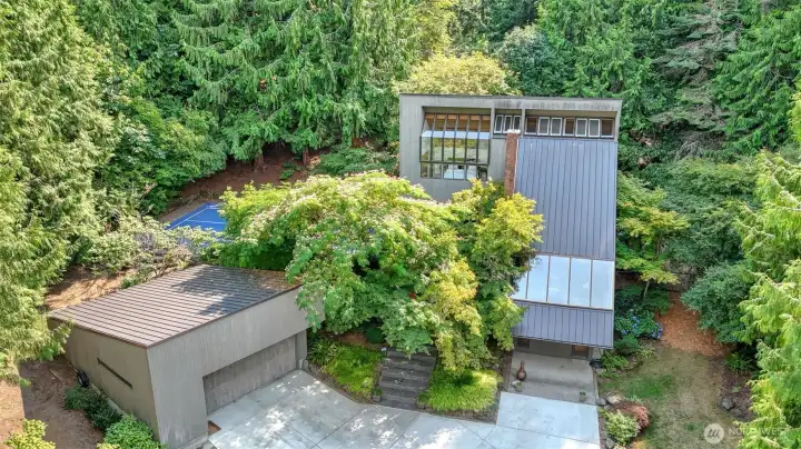 Rare opportunity! This custom-designed home, crafted by a Mercer Island architect, offers a lifestyle as distinctive as it is inspiring. Thoughtfully tailored for both leisure & everyday living, the property showcases a pickleball court & a shed transformed into a versatile studio—perfectly suited for pottery, art space or any hobby that sparks your passion. The multi-level floor plan offers flexibility, ideal for WFH, a home business, or multi-gen living. Set on a large lot w/mature landscaping providing year-round beauty & privacy—all w/no HOA. Whether entertaining, gardening, or enjoying a quiet evening, every detail has been meticulously curated. More than a home, this is a private sanctuary where creativity, comfort & opportunity meet.