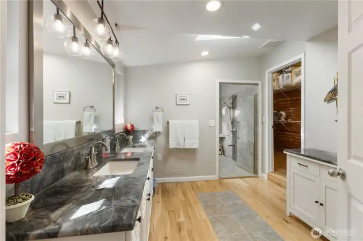 The spa-like Primary Bath includes double vanity and private water closet.