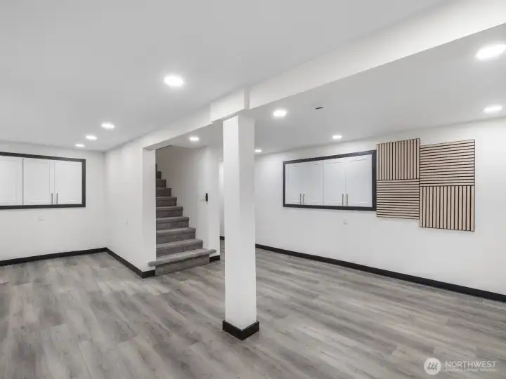 Another view of the fully finished basement with built in cabinetry