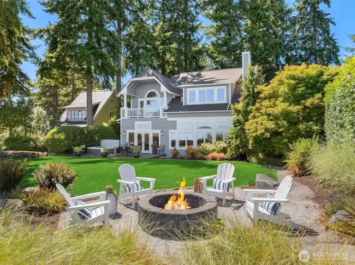 Elevated above the shoreline at the end of a quiet lane, this elegant high-bank waterfront home offers sweeping views, sun-filled outdoor living, and peaceful privacy - an exceptional Bainbridge Island retreat.