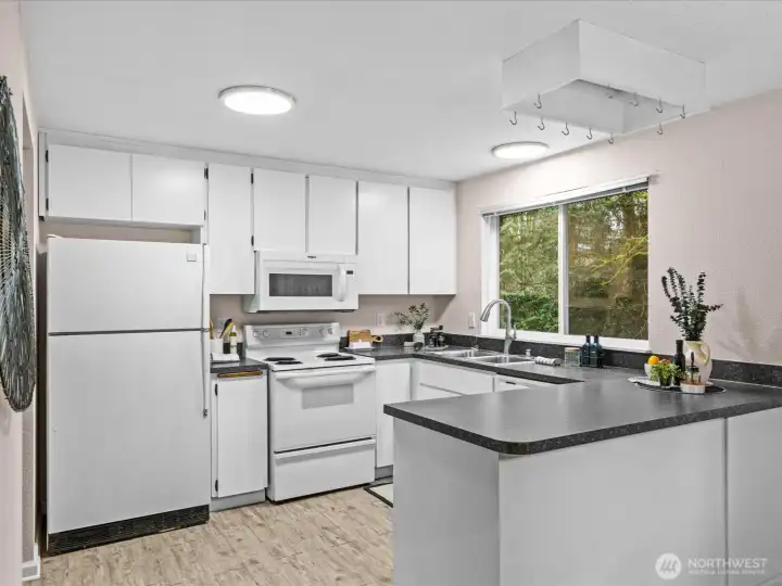 The kitchen offers a practical layout designed for easy meal preparation and conversation.