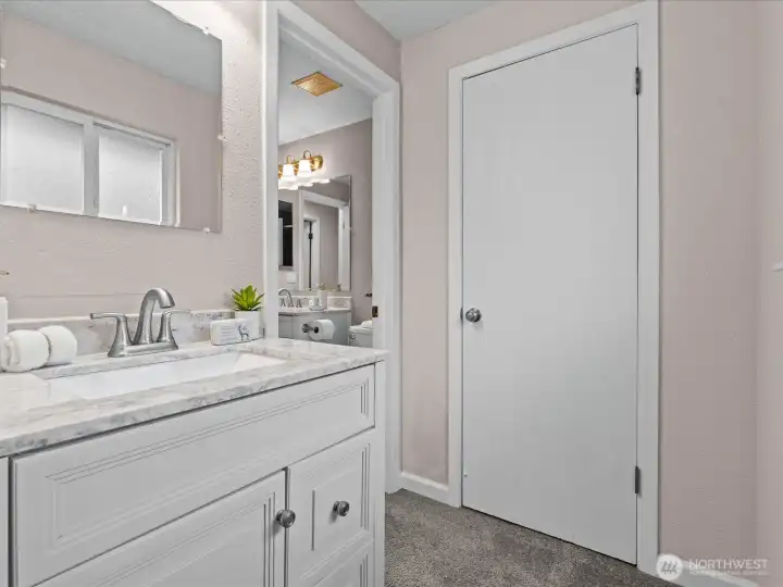 A separate vanity area is located between the primary bedroom and primary bath.