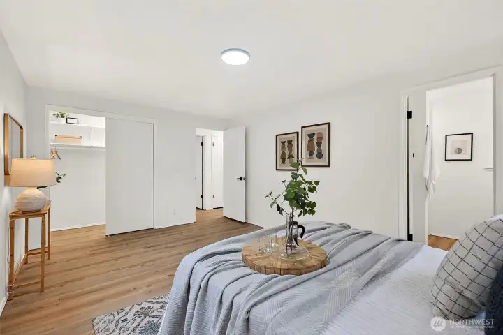 The spacious primary suite features LVP flooring, a walk-in closet, and direct access to the en suite bath, all wrapped in a clean, neutral palette.