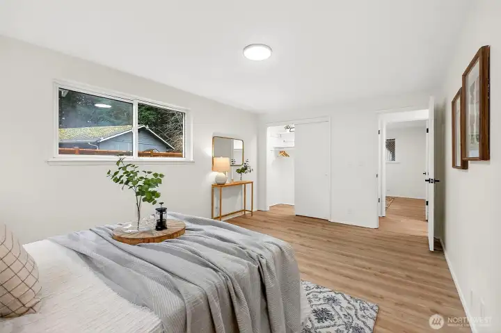 A second angle showcases the primary's generous footprint, dual windows filling the room with natural light, and ample space for a full furniture layout.